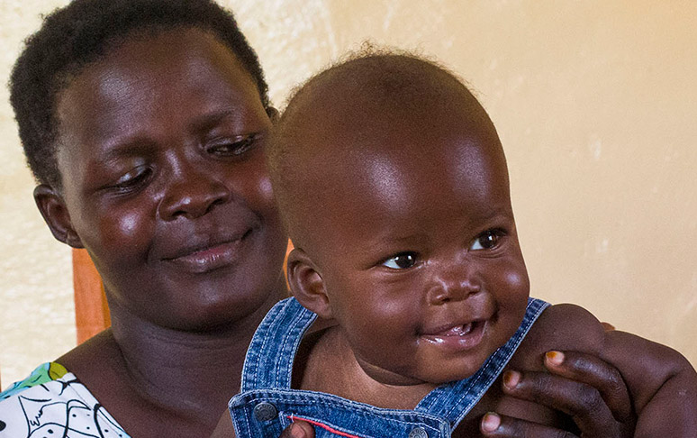 A women holds her baby in rural Kenya