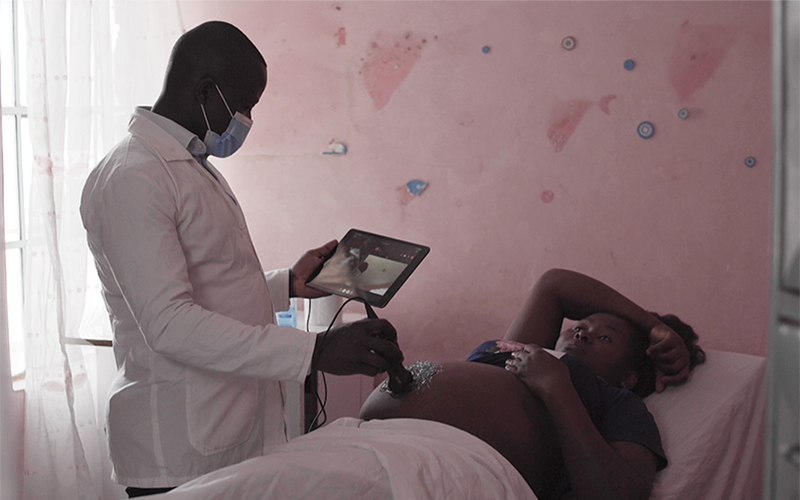 A doctor examines a pregnant women at a medical facility