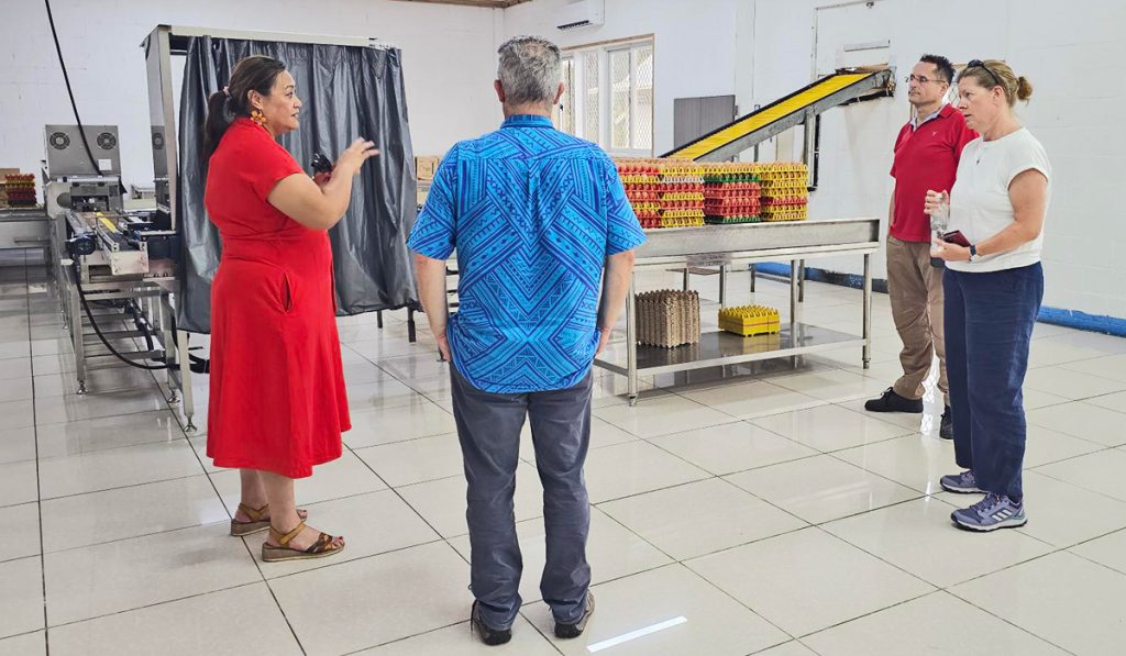 Group of 4 people standing in the Sunshine Pacific egg packing room